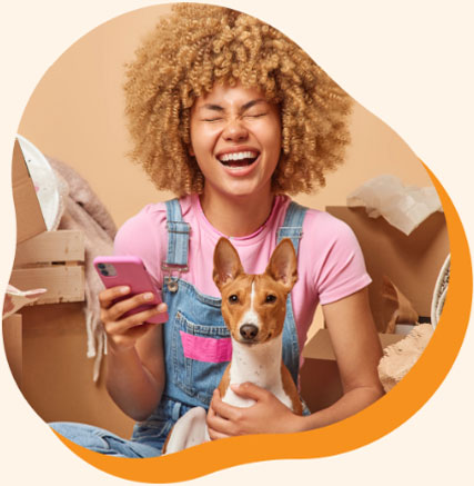 Woman laughing at a text message from her dog